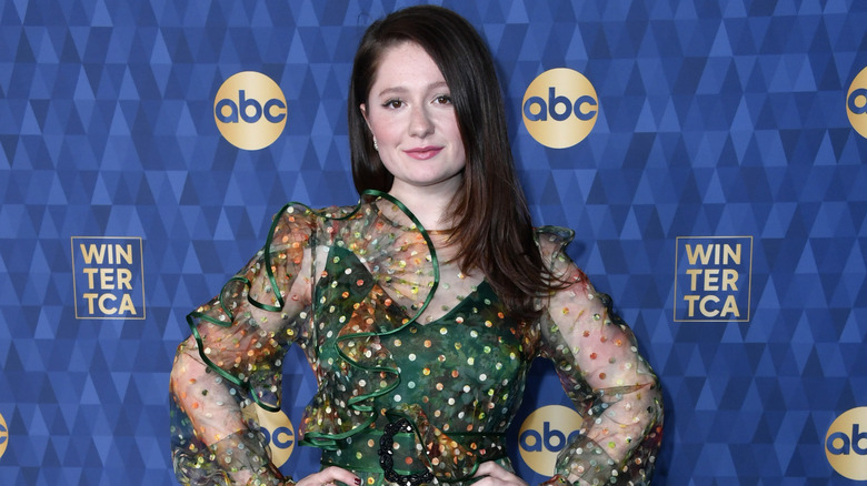 Emma Kenney poses in a green dress