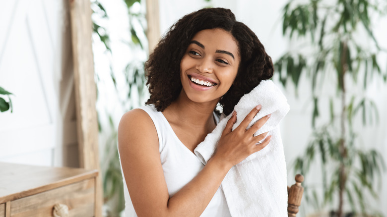 woman drying hair with towel