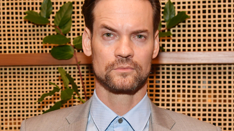 Shane West in gray suit