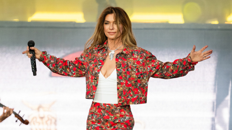 Shania Twain performs onstage holding a microphone