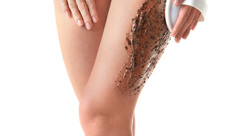 woman exfoliating legs