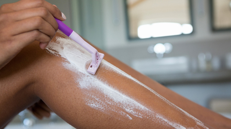 woman shaving legs