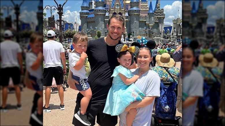 Shawn Johnson East, Andrew East, and children smiling at Disney World