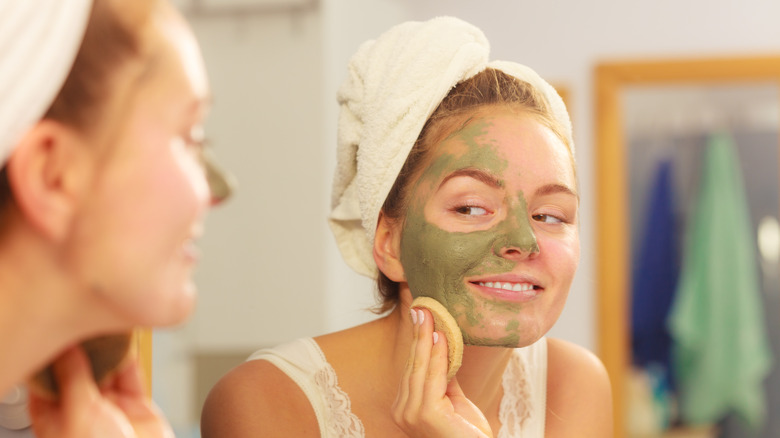 Woman applying a mud mask