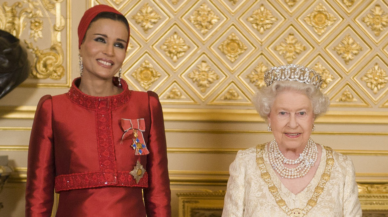 Sheikha Moza smiling with Queen Elizabeth