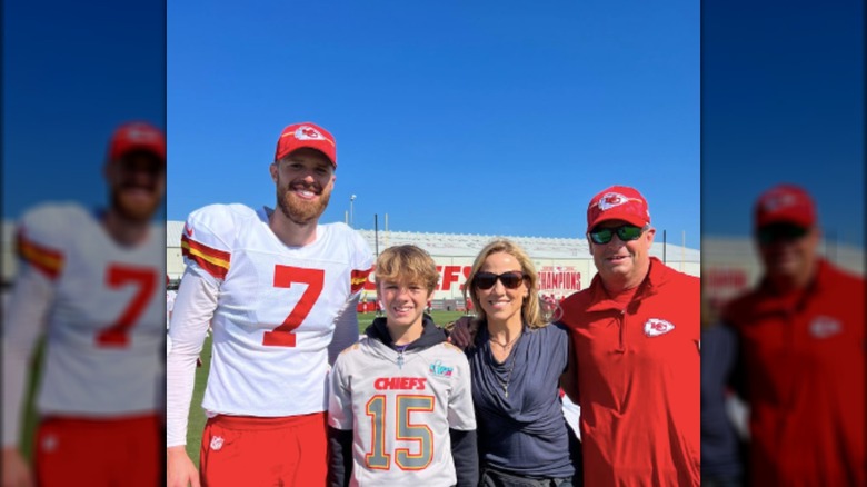 Levi Crow and Sheryl Crow smiling with NFL stars