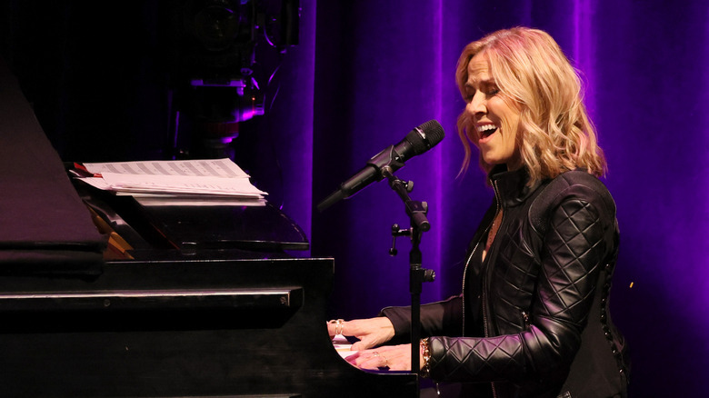 Sheryl Crow playing piano, singing