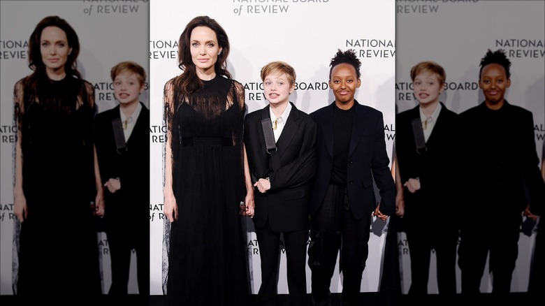 Angelina Jolie posing with Shiloh and Zahara Jolie-Pitt