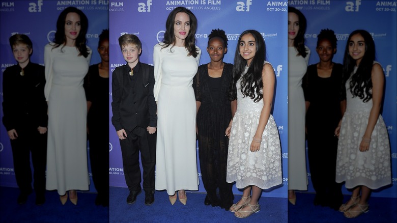 Angelina Jolie posing with Shiloh and Zahara Jolie-Pitt