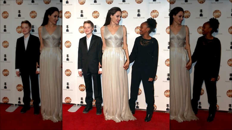 Angelina Jolie posing with Shiloh and Zahara Jolie-Pitt