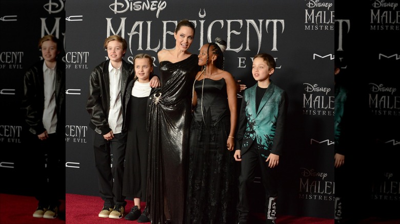 Angelina Jolie posing with her kids at Maleficent premiere