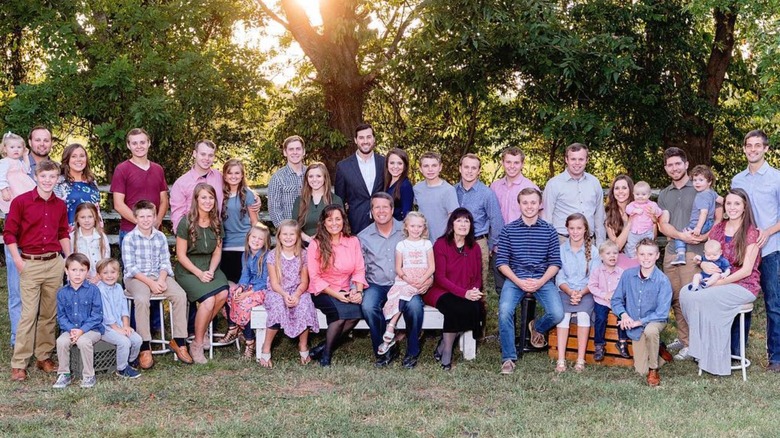 The Duggar family posing outside