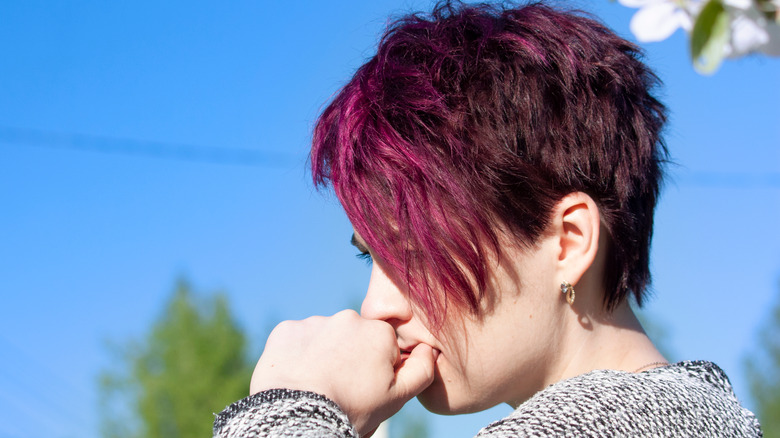 short hairstyle of a pixie with side-swooping bangs