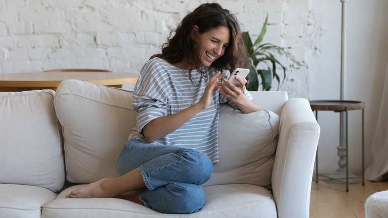 Woman smiling at her her phone 