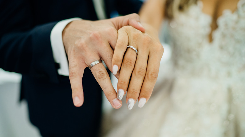 couple showing wedding rings