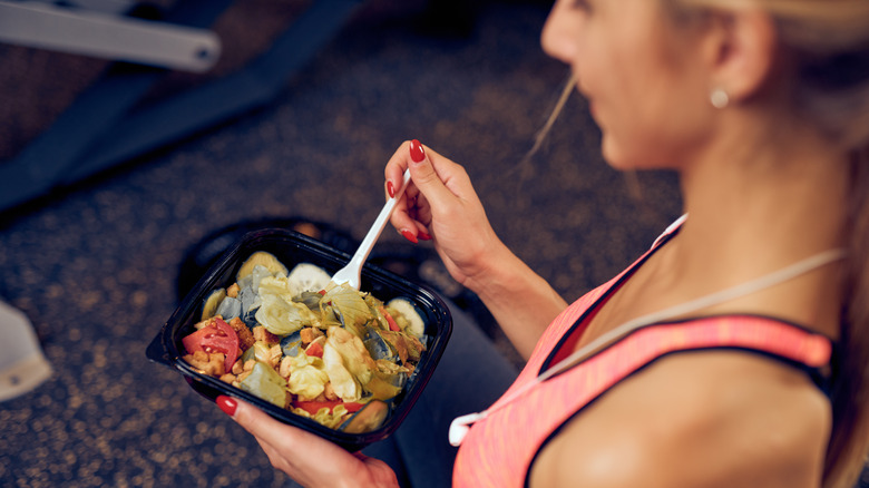 Woman eating while working out 