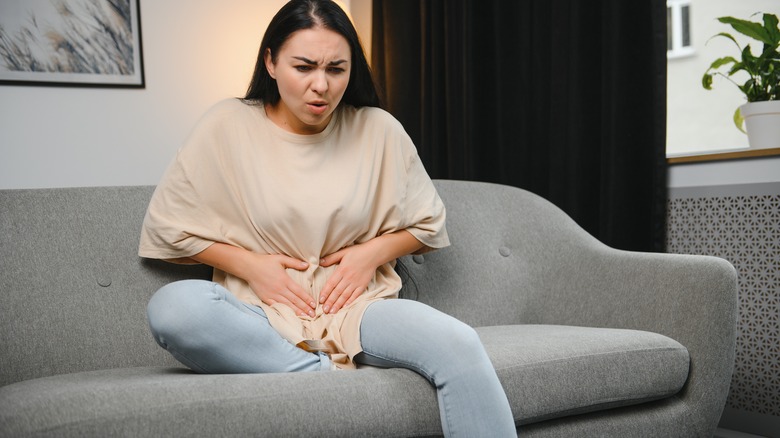 Woman holding her abdomen