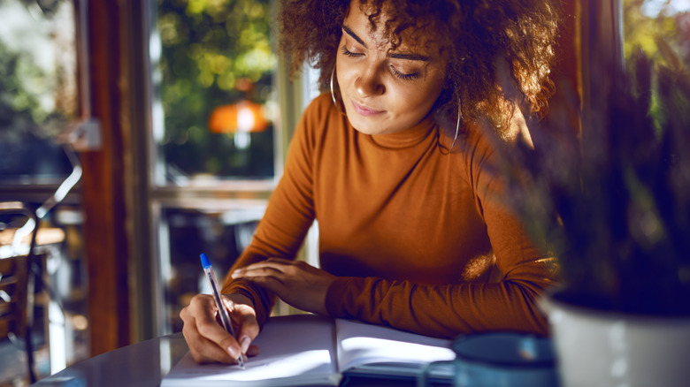 Woman writing in her journal