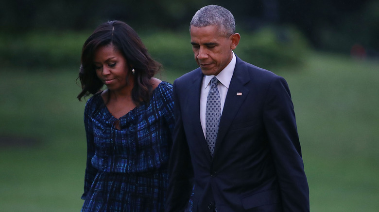 Barack and Michelle Obama holding hands