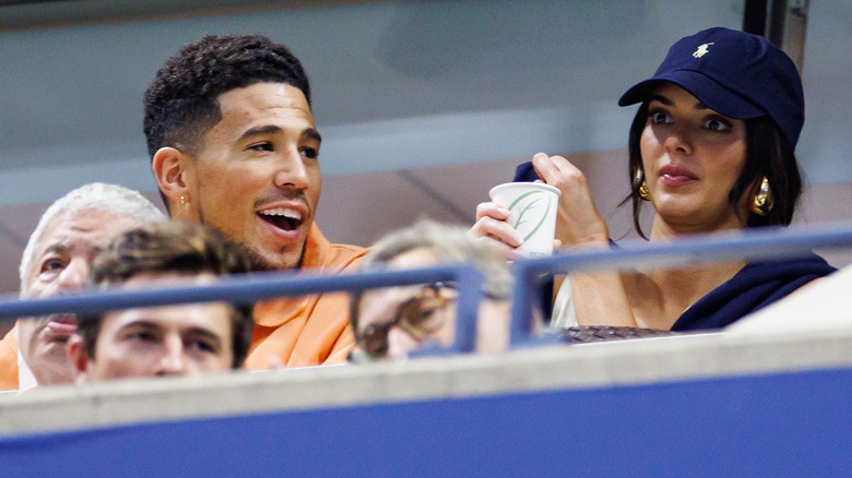 Kendall Jenner and Devin Booker watching a game