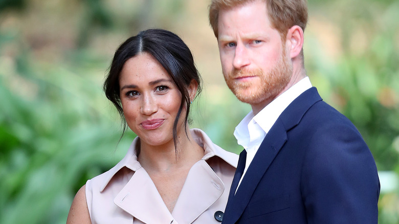 Prince Harry and Meghan Markle looking at the camera