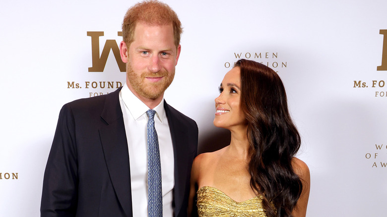 Prince Harry and Meghan Markle posing at event