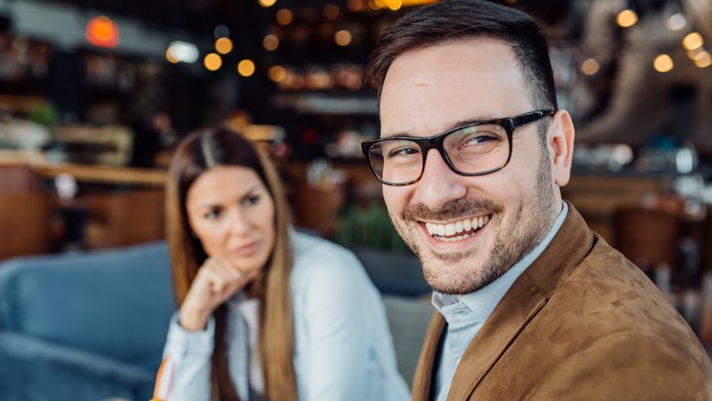 man looking at another woman