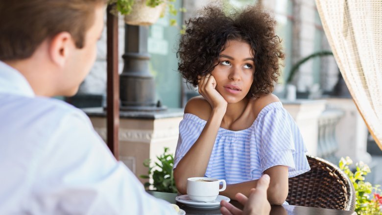 woman disinterested in conversation with man