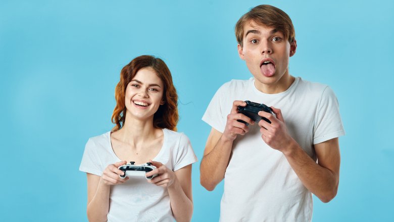 man and woman playing xbox