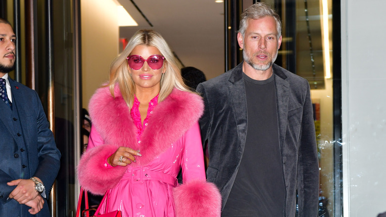 Jessica Simpson in  ahot pink outfit and Eric Johnson leaving leave BuzzFeed