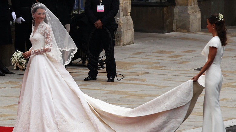 Pippa holding Kate's wedding dress