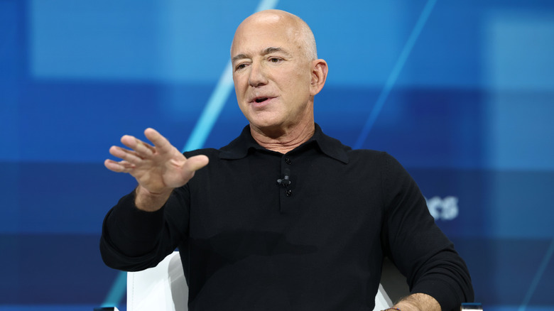 Jeff Bezos dressed in a black shirt speaking at an event