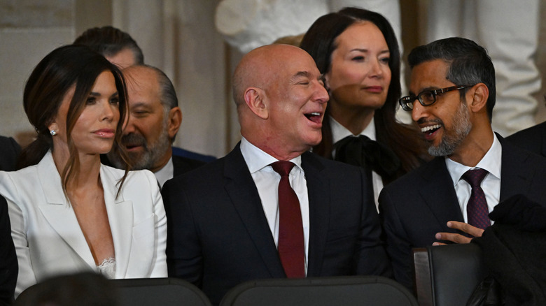 Lauren Sánchez sitting next to Jeff Bezos socializing and laughing