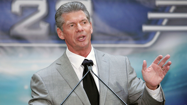 Vince McMahon speaking hand raised