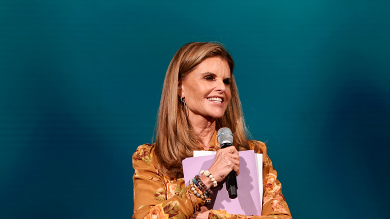 Maria Shriver holding a microphone