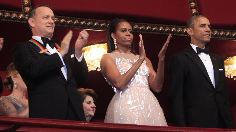 Tom Hanks, MIchelle Obama, and Barack Obama clapping