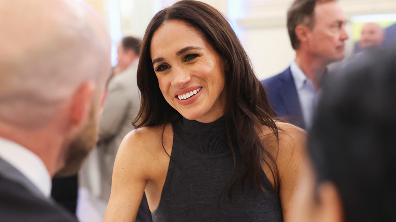 Meghan Markle smiling and speaking 