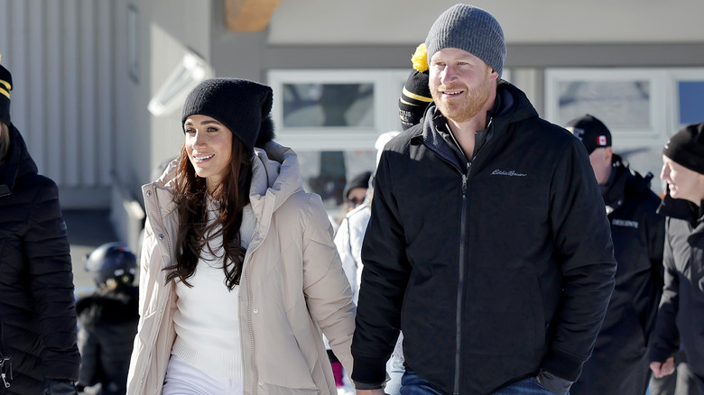 Prince Harry and Meghan Markle holding hands