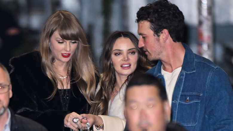 Taylor Swift, Keleigh Sperry, and Miles Teller walking together
