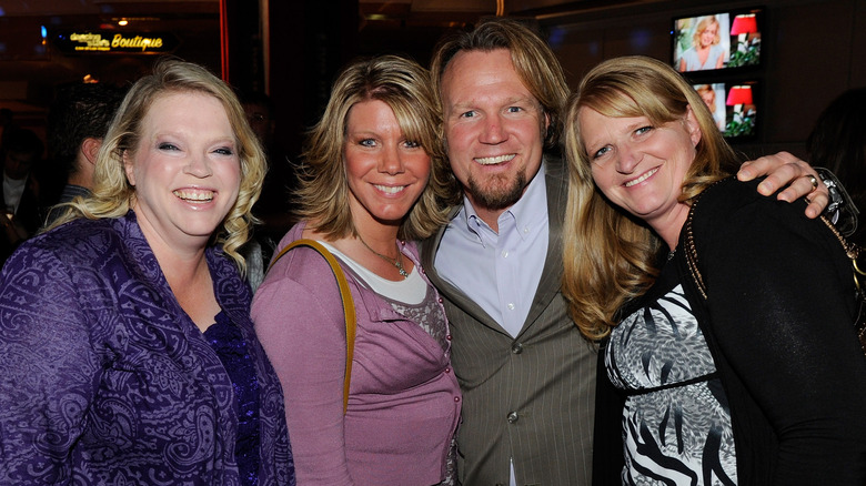 Kody Brown with three of his wives, smiling