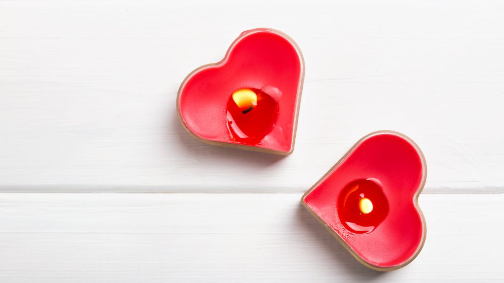 two heart candles on a white tabletop 