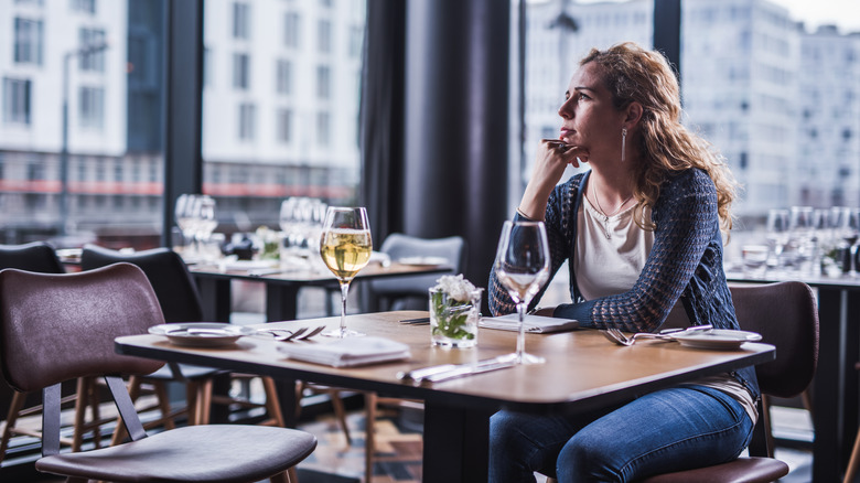 woman waiting at table alone