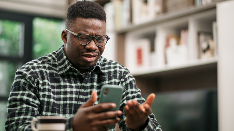 man annoyed at text