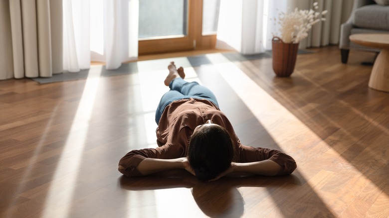 woman laying on floor peacefully 