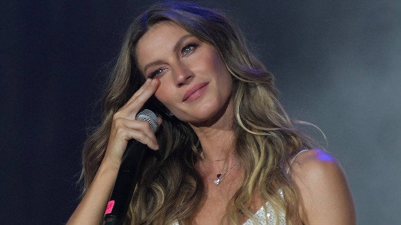 Gisele Bündchen wiping tear