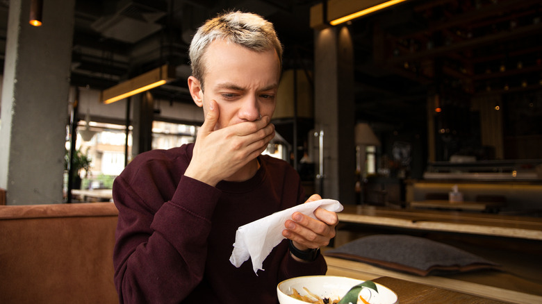 man at table suspects food allergy