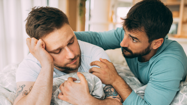 Man comforting sad partner