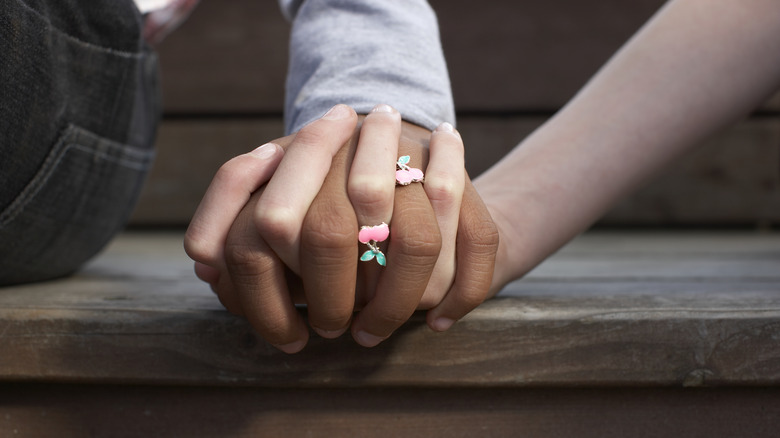 Couple holding hands