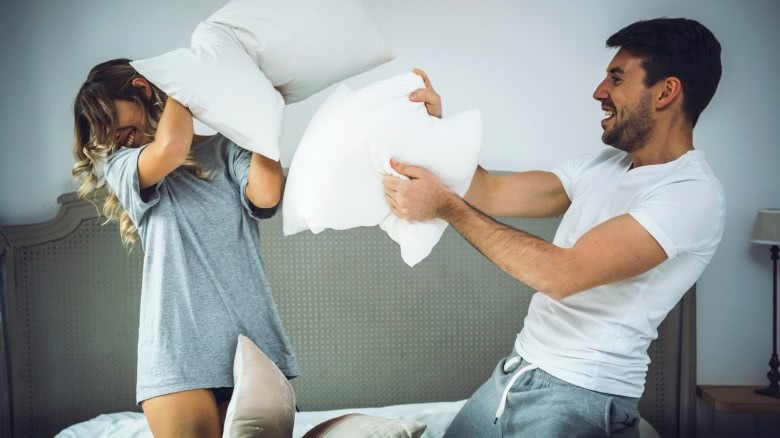 couple having pillow fight