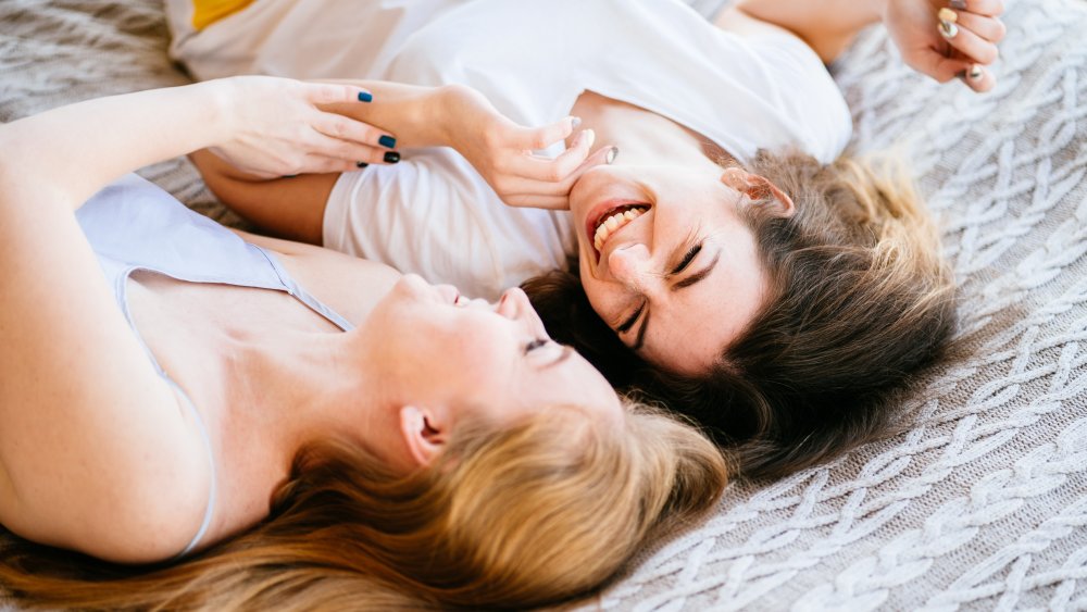 Two women laughing and talking